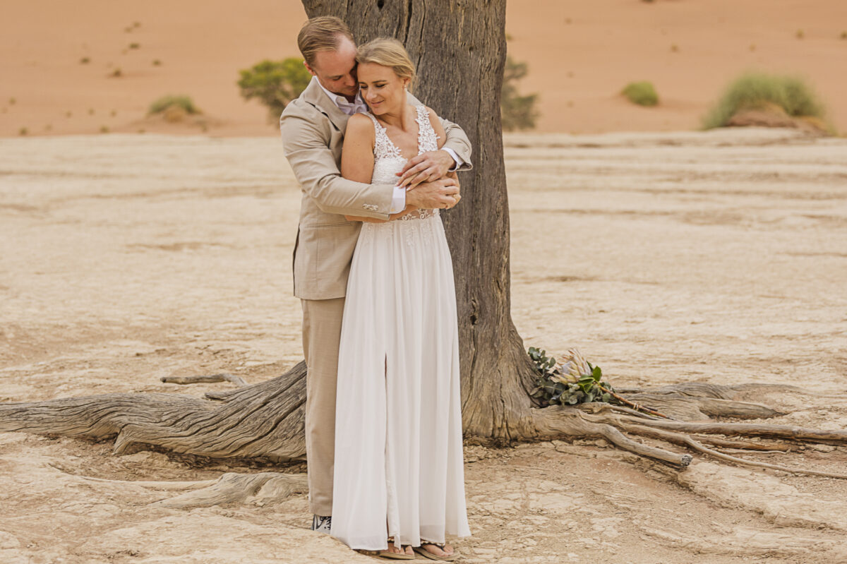 Bride and groom during their wedding photoshoot in Sossusvlei, image by Mariette du Toit Photography