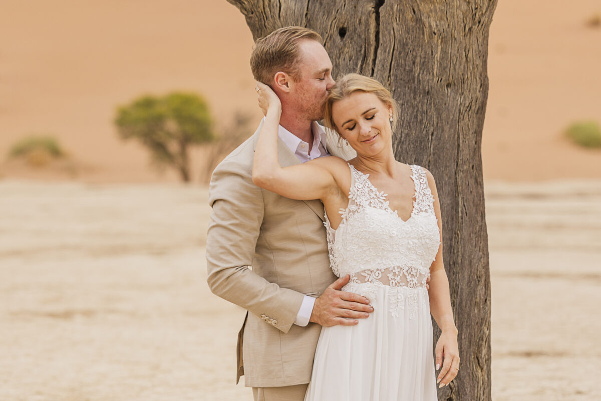 Bride and groom during their wedding photoshoot in Sossusvlei, image by Mariette du Toit Photography