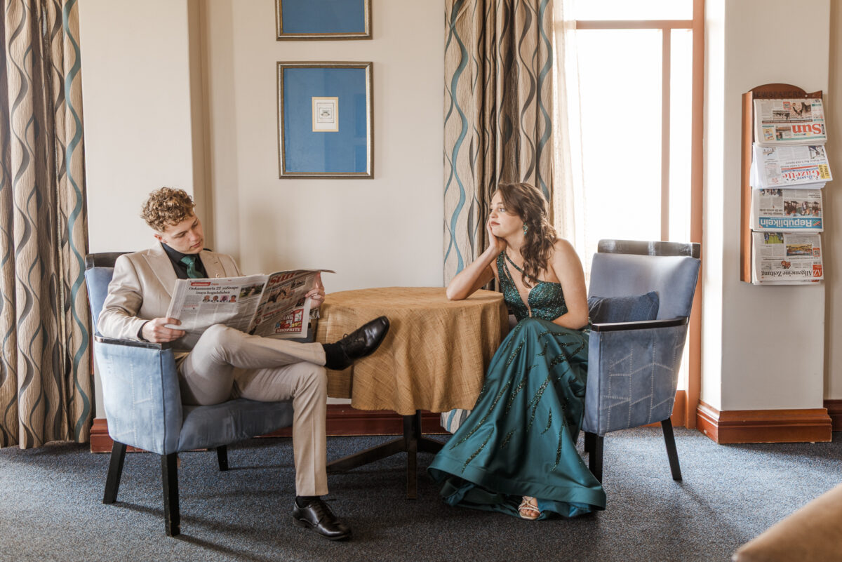 image of boy and girl reading newspaper in hotel during matric farewell photo shoot, walvis bay, namibia, mariette du toit photography