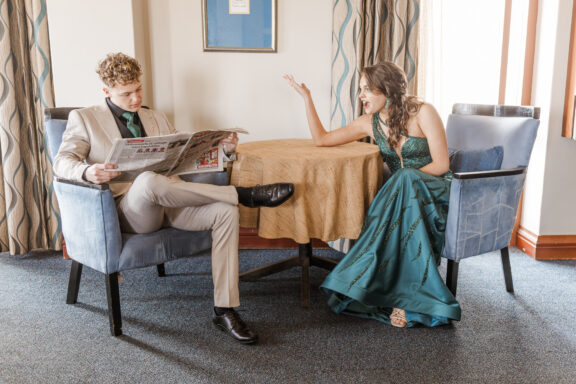 image of boy and girl reading newspaper in hotel during matric farewell photo shoot, walvis bay, namibia, mariette du toit photography