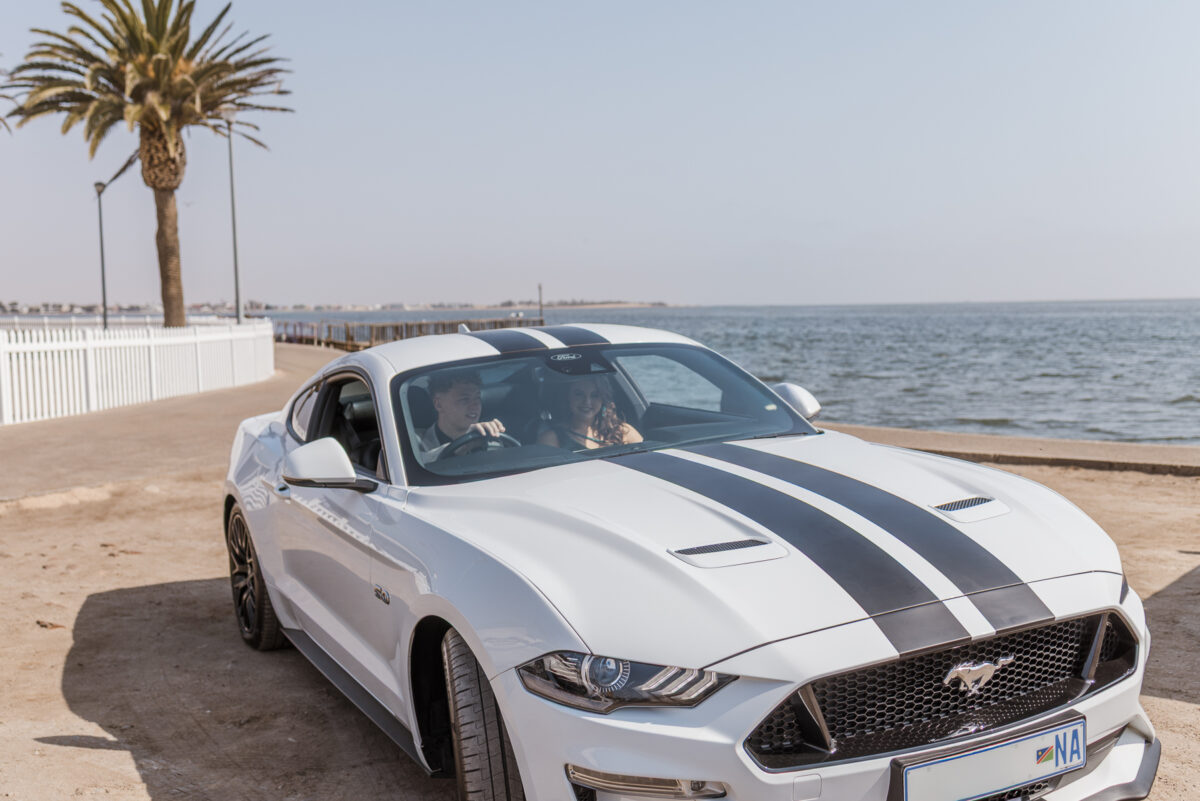 boy and girl with ford mustang at walvis bay lagoon during matric photos by mariette du toit photography