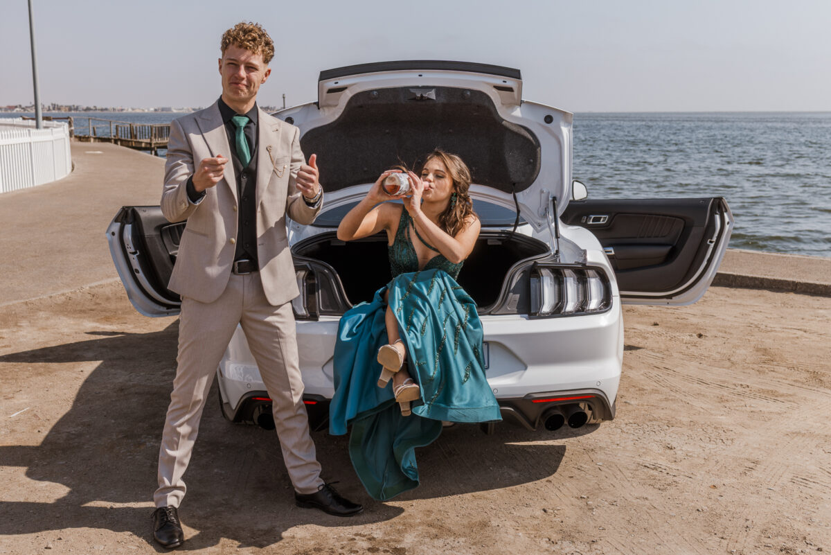 boy and girl with ford mustang at walvis bay lagoon during matric photos by mariette du toit photography