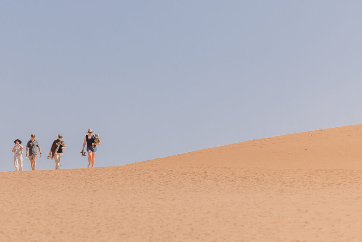 family-photo-shoot-in-sossusvlei-namibia, image of family walking by mariette du toit photography