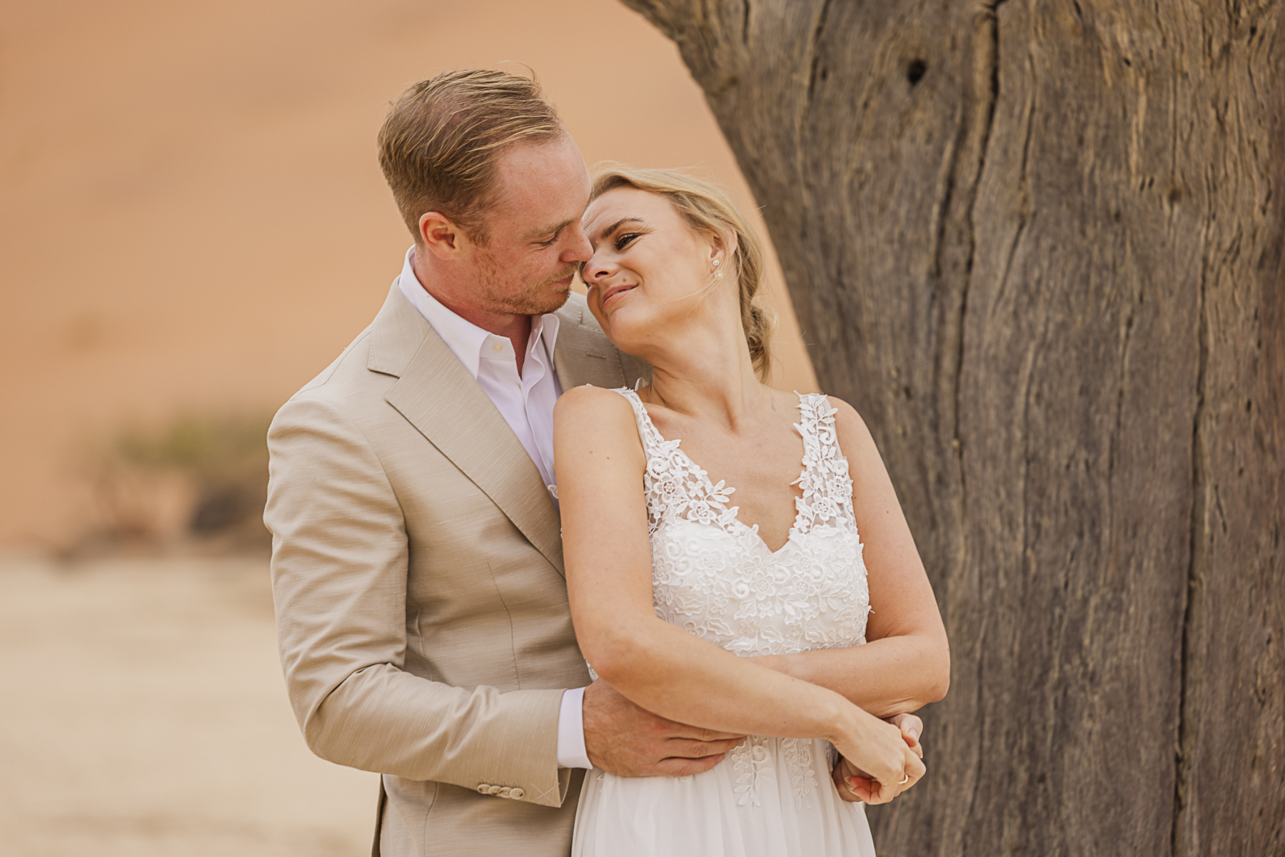 couple in embrace in deadvlei, namibia during elopement