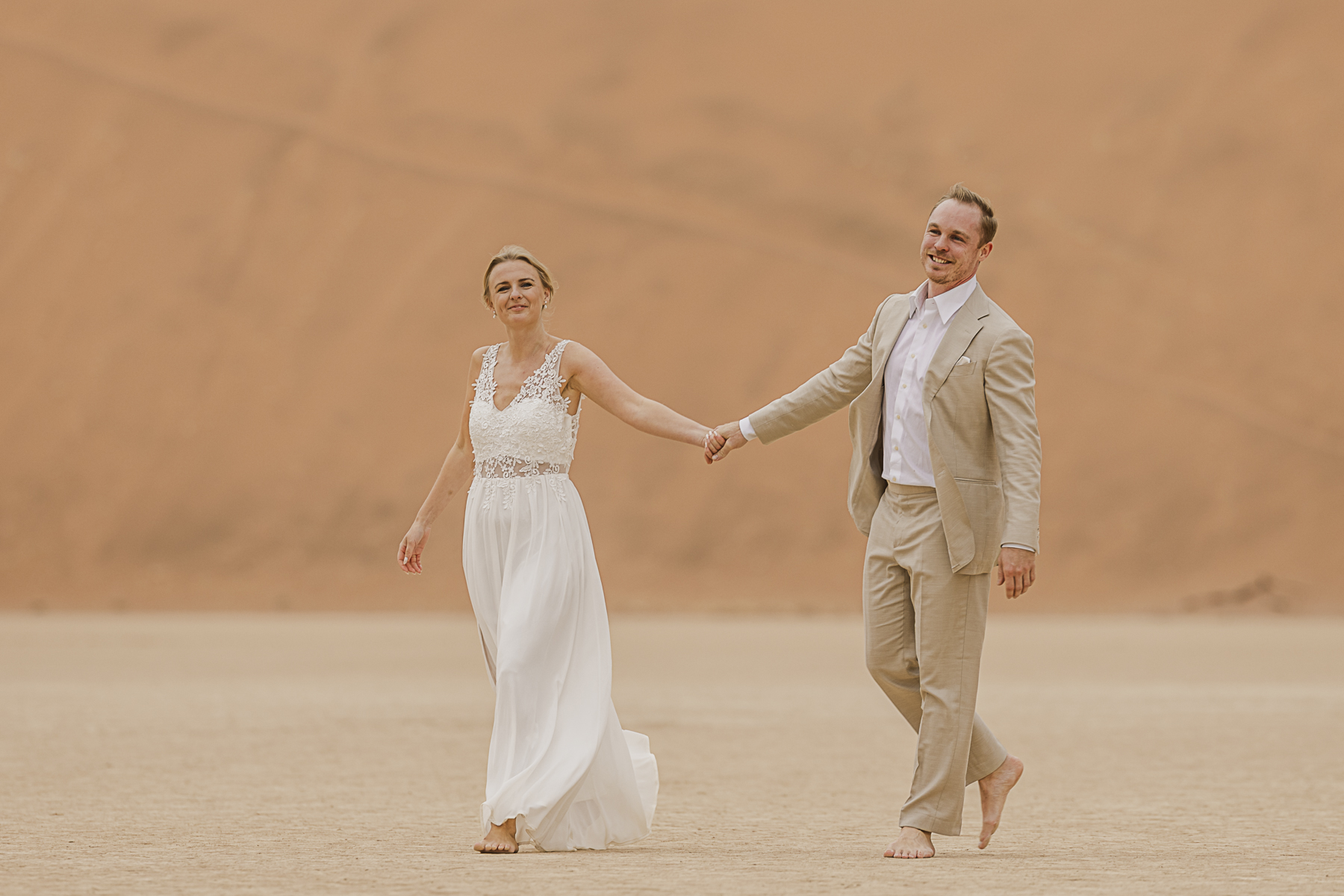 couple walking in deadvlei, namibia during elopement