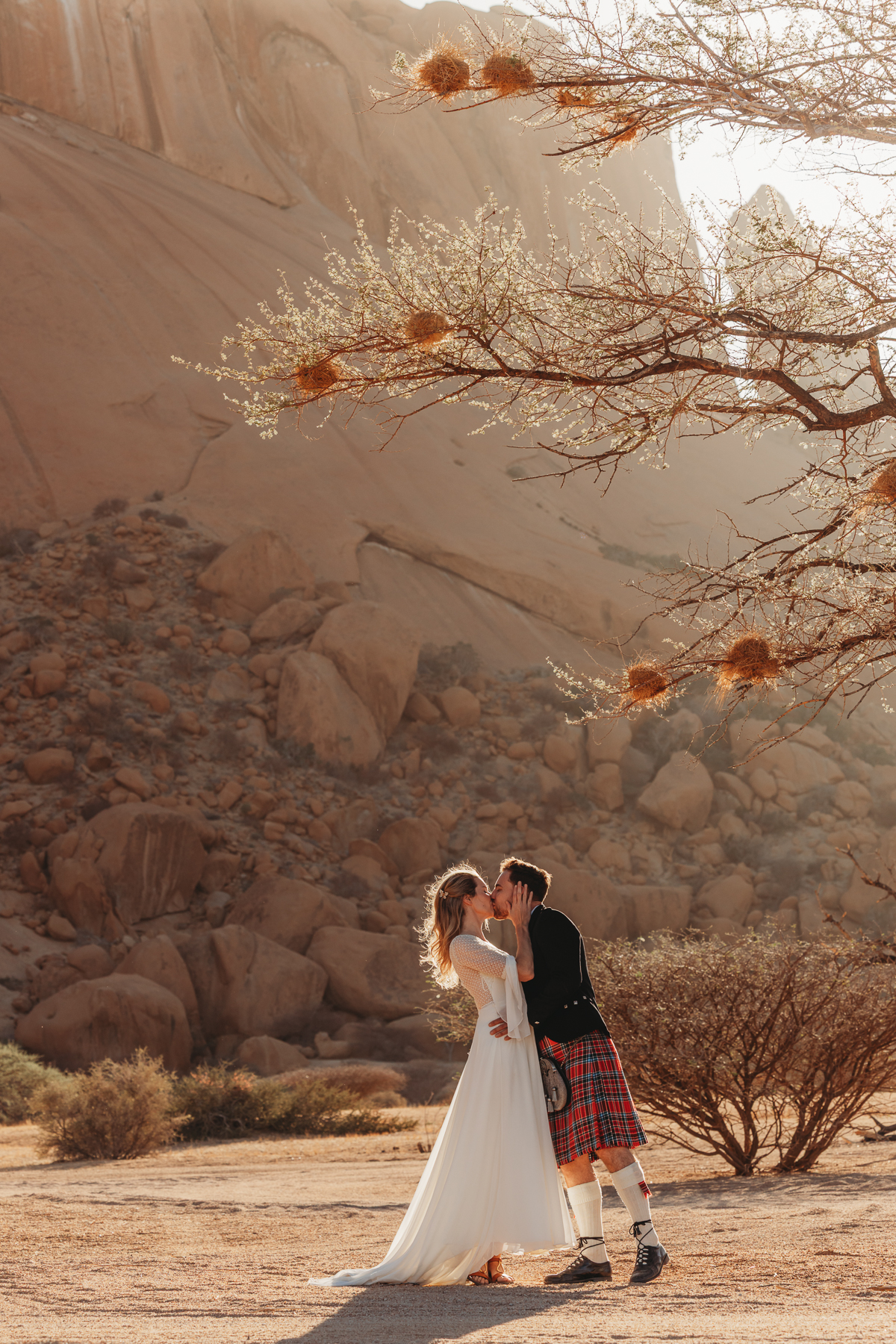 couple kissing in golden sunlight, spitzkoppe namibia