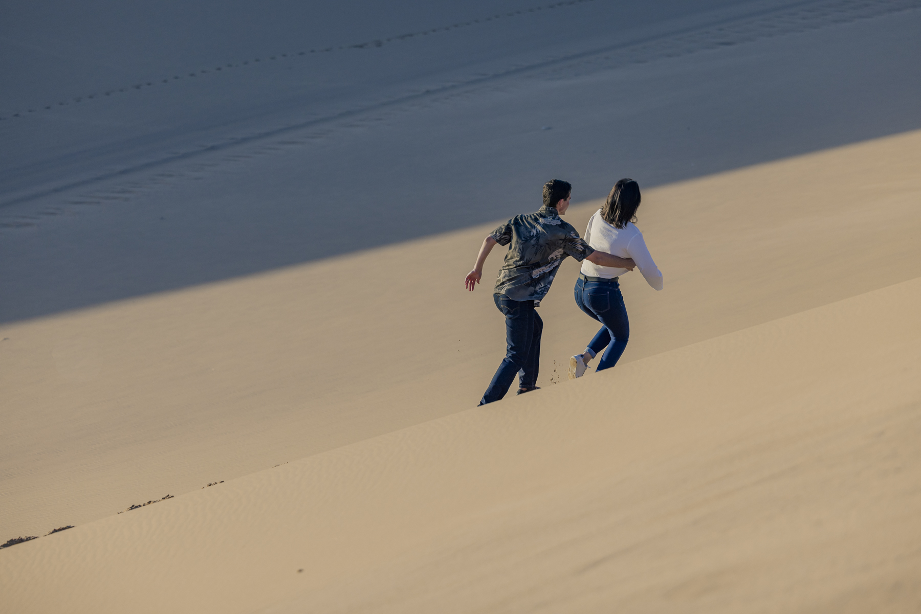 couple playing in namib desert dunes