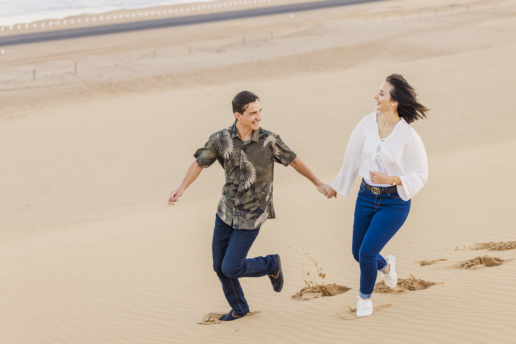 couple running in swakopmund dunes