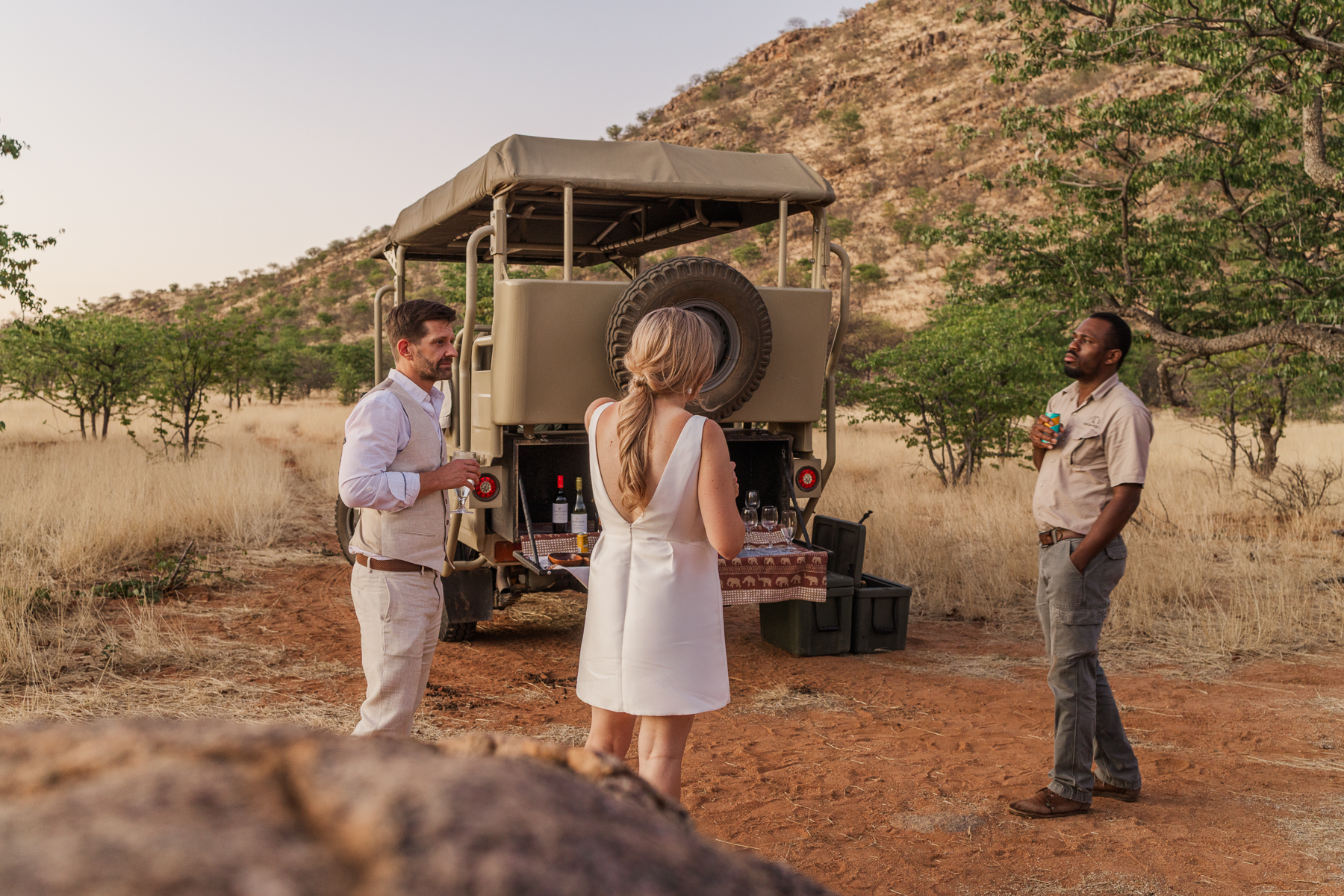 Couple sharing champagne while watching sunset during their Namibia elopement