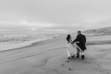 wedding couple walking on Henties beach