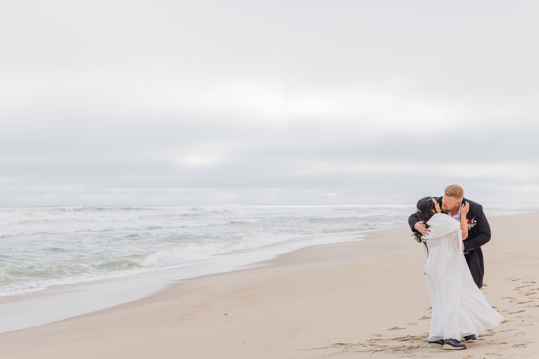 wedding couple walking on Henties beach