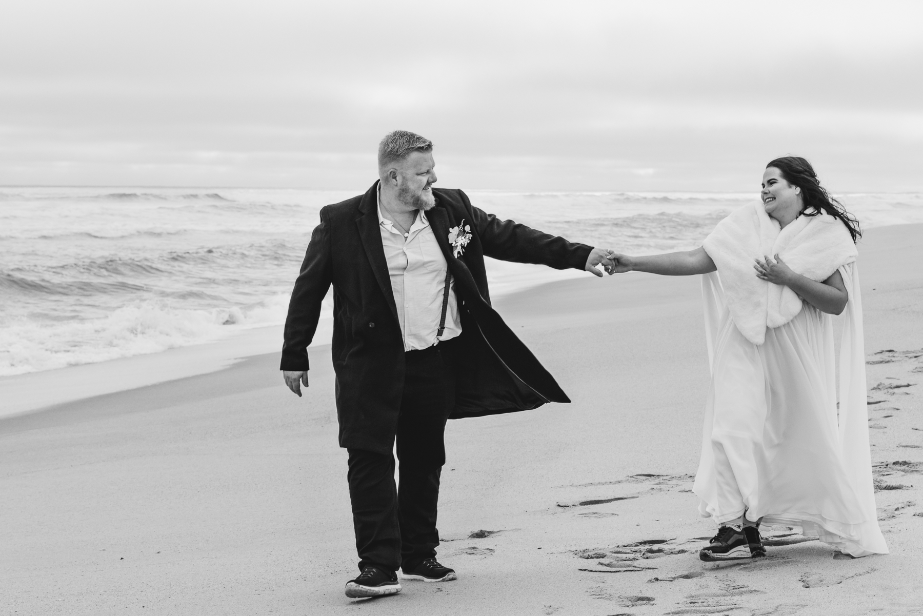 wedding couple walking on Henties beach