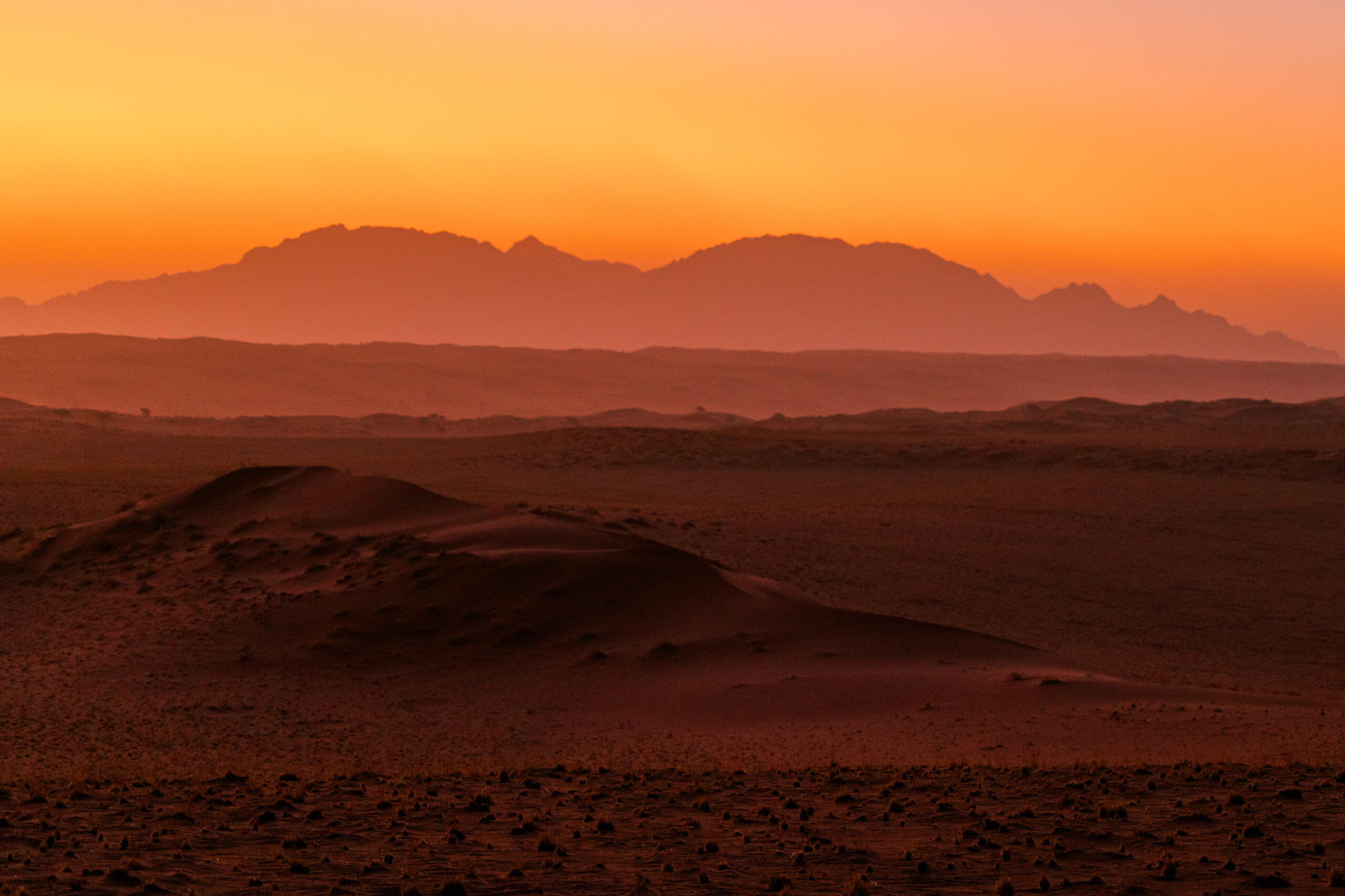 Sunset glowing over the mountains of the NamibRand Nature Reserve near Wolwedans