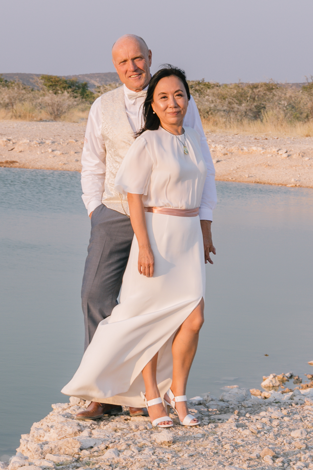 Couple at the water’s edge on their elopement day in Etosha National Park