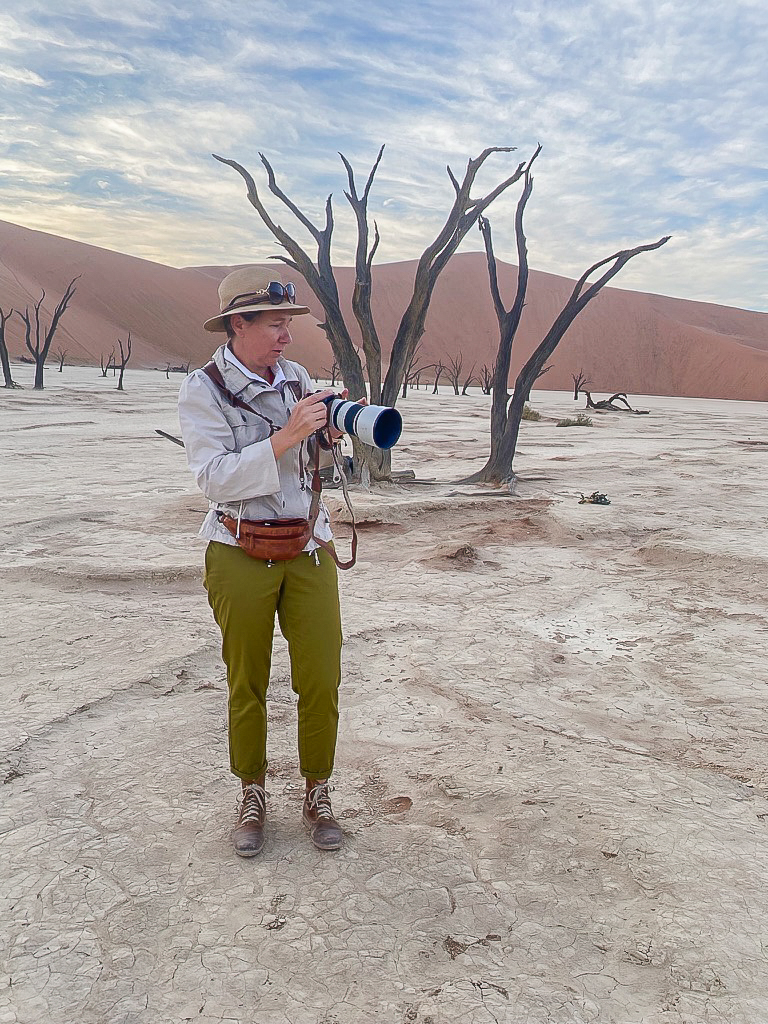 Mariette du Toit photographing among the dead camelthorn trees of Deadvlei, Namibia